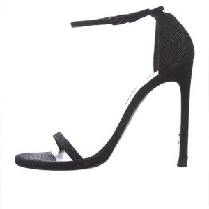 Black Stuart Weitzman heeled sandals.